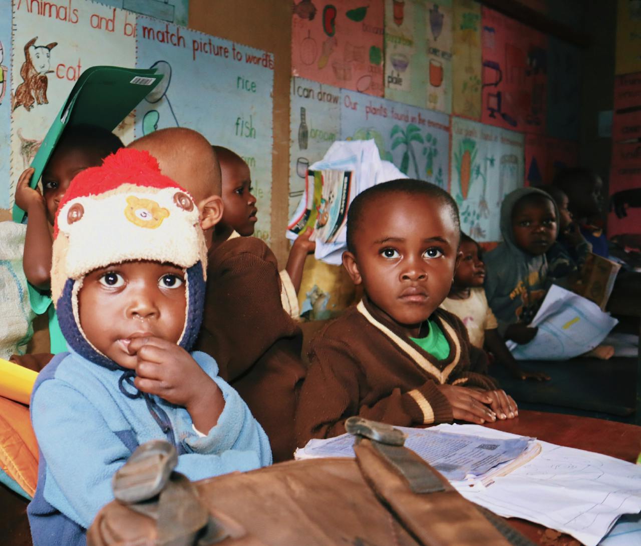 Children attentively seated in a vibrant classroom, immersed in educational activities.